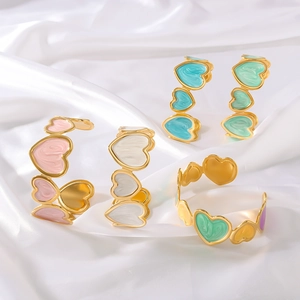 Colorful enamel heart-shaped open cuff bracelets on elegant white satin fabric