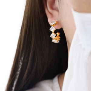 Elegant 18K gold-plated C-shaped hoop earrings featuring five square cubic zirconia stones