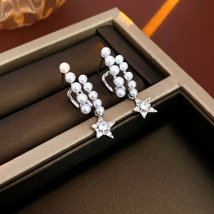 Detail of silver star earrings with double rows of pearls and sparkling zircon charms
