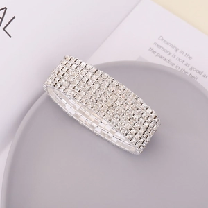 Sparkling multi-row crystal stretch bracelet in silver finish for women on gray display