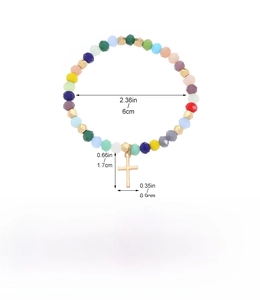 Detail view of colorful beaded bracelet featuring a gold cross pendant and sizing metrics
