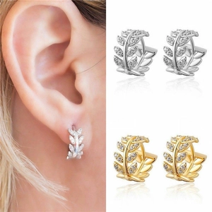 Macro view of micro-pave leaf branch earrings in gold and silver finish options