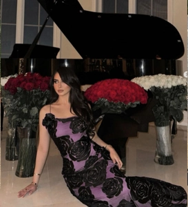 Macro detail of purple evening gown with black 3D floral velvet textures and lace