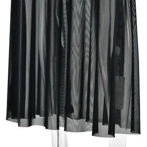 Detail of sheer black mesh dress hem showing transparent texture and pleated design