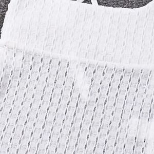 Detailed macro view of white pleated fabric texture with high elastic ruched stitching