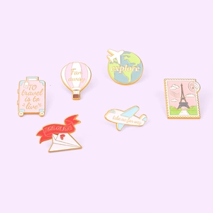 Travel themed enamel pins set with suitcase, hot air balloon and globe shapes