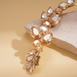 Detailed shot of champagne leaf-shaped crystal necklace with gold-plated setting
