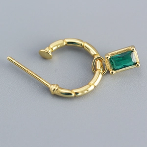 Macro shot of 925 sterling silver stamp on vintage gold C-shaped emerald zircon earrings