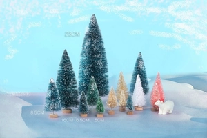 Various sizes of mini sisal Christmas trees with wood bases and a polar bear decoration