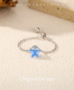 Detail of adjustable S925 silver chain ring featuring a blue crystal star pendant