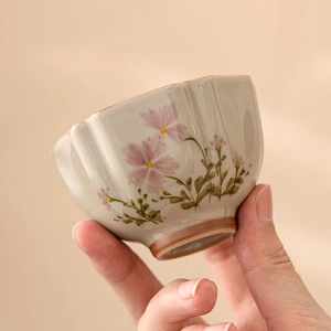 Ash grey ceramic teacup with pink daisy pattern and textured handcrafted finish