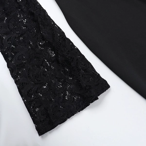 Close-up of elegant lace cuffs and smooth black fabric on women's long sleeve jumpsuit
