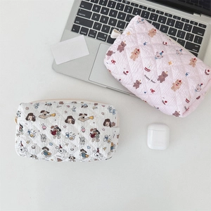 Close-up of quilted cosmetic bags featuring cute cartoon bear and puppy patterns