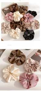 Close-up of premium satin hair scrunchies in earthy tones with elegant silk luster