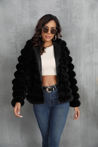Detailed view of black faux fur jacket texture with unique 3D bubble patchwork design