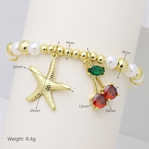 Detail shot of pearl and gold bead bracelet with cherry and starfish charms