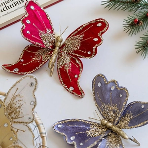 Macro view of velvet Christmas butterfly clips with sequins, rhinestones, and metal clip