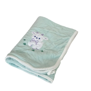 Soft mint green fleece bath towel with white lamb embroidery and braided edges
