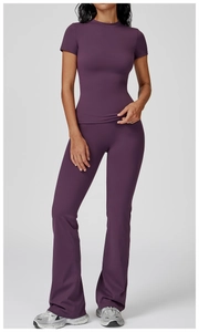 Detail of high-stretch purple yoga set with crew neck top and flared fitness leggings