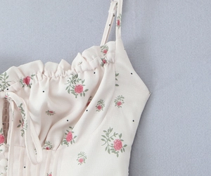Detail of floral spaghetti strap top with ruffle trim and lace-up front design