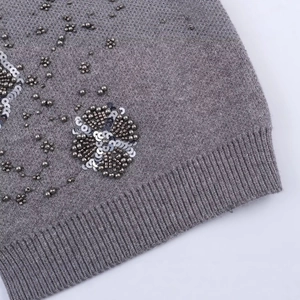 Grey knit cardigan with detailed beadwork and floral sequin embroidery on ribbed edge