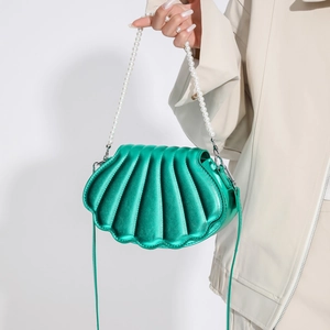 Metallic green shell shaped crossbody bag with pearl handle and pleated texture