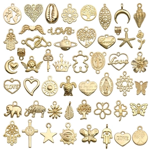 Assorted gold alloy DIY charms featuring heart, tree of life, and celestial patterns