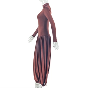 Macro shot of dark brown high-neck ribbed jumpsuit showing fabric texture and waist detail