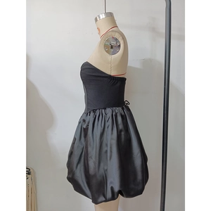 Detail of elegant black strapless cocktail dress with a satin bubble hem and elastic waist