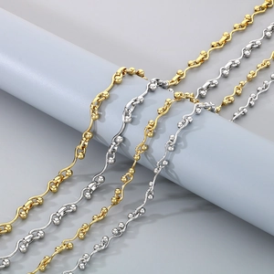 Hip hop style gold and silver interlocking geometric beaded chain necklaces on a stand