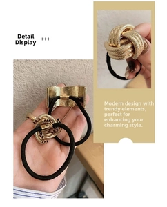 Detail showing two gold metal hair ties with twisted knots and smooth arc textures