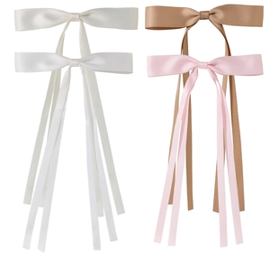 Detailed set of four satin bow hair clips in white, beige, pink, and brown colors