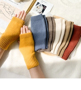 Collection of knitted fingerless gloves in various warm colors for winter typing