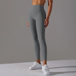 Detail showing high-waisted gray yoga pants with wide tummy control waistband