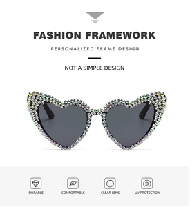Detail view of heart-shaped sunglasses with colorful AB rhinestones and UV protection lens