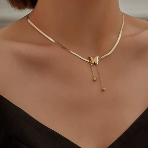 Elegant gold butterfly pendant necklace with tassels on snake chain shown on model neck