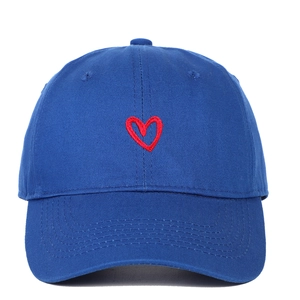 Close-up of a blue baseball cap featuring a detailed red heart embroidery on the front