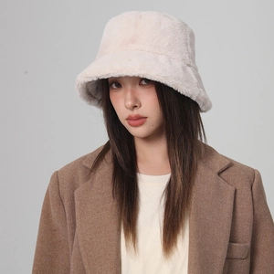 Close-up of a cozy beige plush bucket hat featuring soft thick faux fur for winter warmth