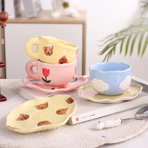 Cute ceramic coffee cup and saucer set featuring hand-painted bears and floral patterns