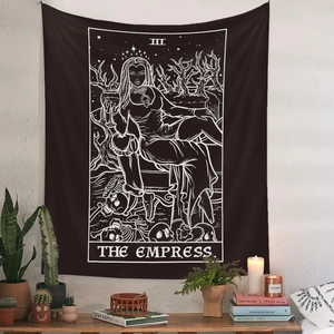 Bohemian Tarot Empress tapestry with gothic skull design on a white brick wall