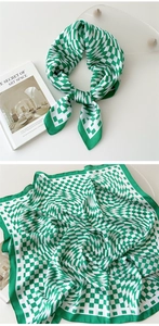 Detail of green and white warped checkerboard silk scarf styled with art props