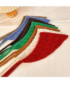 Multiple colors of vintage knitted triangle scarves showcasing wool textures and warm hues