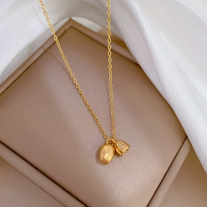 Detailed close-up of gold tulip pendants on a delicate titanium steel chain necklace