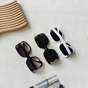 Close-up of stylish oversized square sunglasses with metal trim and gradient lenses
