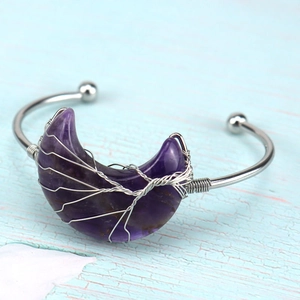 Macro detail of purple amethyst moon stone with silver wire wrap on bohemian cuff
