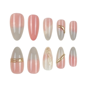Almond-shaped press-on nails with pink grey gradient and gold relief line designs