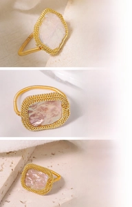 Macro detail of Baroque natural freshwater pearl ring with 18K gold plated wire wrapping