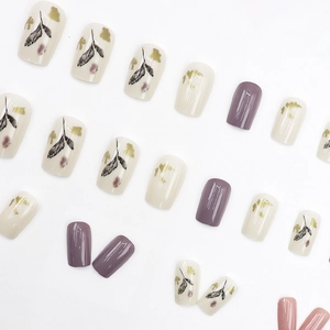 Short square purple press-on nails with ink wash leaf patterns and gold foil accents