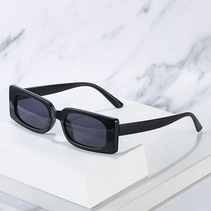 Classic black square frame sunglasses with dark grey lenses on marble background