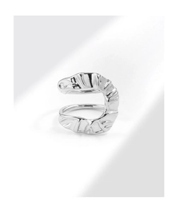 Macro shot of silver U-shaped ring featuring textured folds and modern artistic style